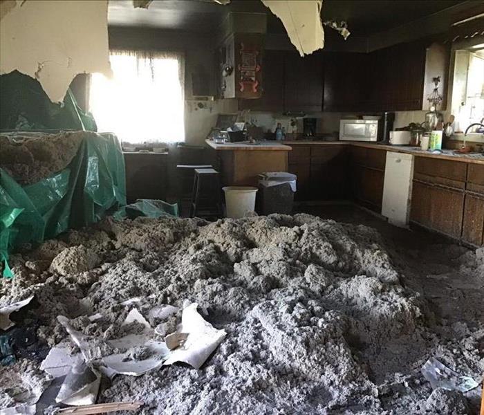 Heavy rains cause the ceiling to collapse in a kitchen